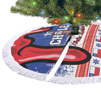 Blue Chile Christmas tree skirt with red wave graphic and white fringe trim, laid flat