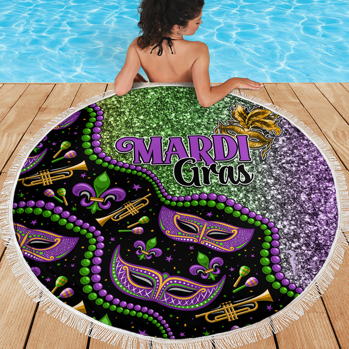 Round beach blanket with central Mardi Gras text and glittery green purple graphics, fringe edge