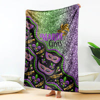 Mardi Gras blanket with glitter green and purple design, purple masks and bead pattern