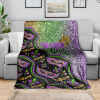 Mardi Gras blanket draped over sofa, glitter green and purple with mask and fleur pattern