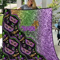 Black Mardi Gras quilt with green and purple glitter-style pattern and mask graphics