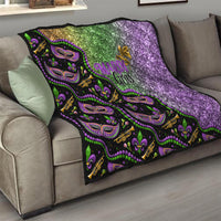 Black Mardi Gras quilt on sofa with green top and purple sparkle side plus mask pattern
