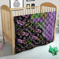 Black Mardi Gras quilt for kids with green and purple glitter sections and mask faces