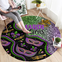 Round carpet with “MARDI Gras” graphic, purple and green patterns, on wooden floor.