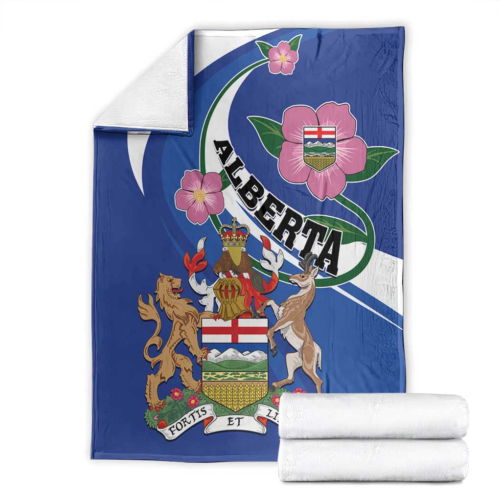 Blue Alberta crest blanket with wild rose flowers; folded with two white rolled towels