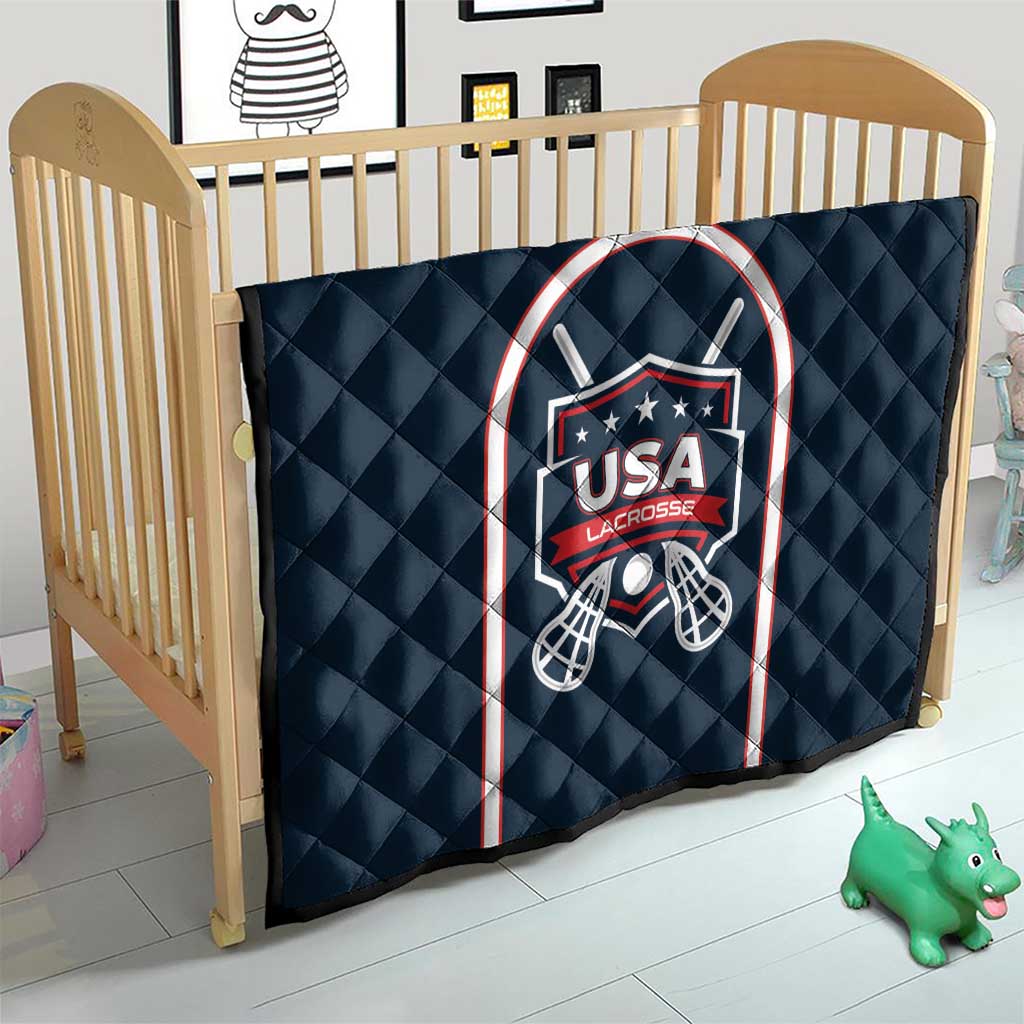Navy blue lacrosse quilt in crib with USA Lacrosse shield and mesh goal design
