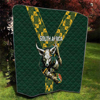 Green quilted South Africa rugby blanket outdoors with V stripe design and horned mascot