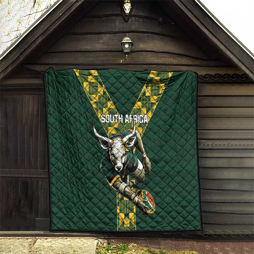 Green quilted South Africa rugby blanket hanging on a wall with V stripe logo and horned mascot