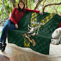Green quilted South Africa rugby blanket with V stripe logo and horned mascot, draped on a couch
