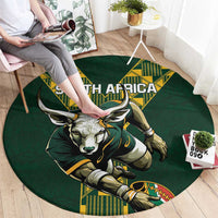 Green round rug close-up with South Africa wordmark and bull mascot graphic in yellow.