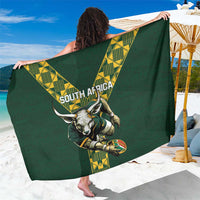Green patterned sarong with yellow geometric border and animal crest graphic