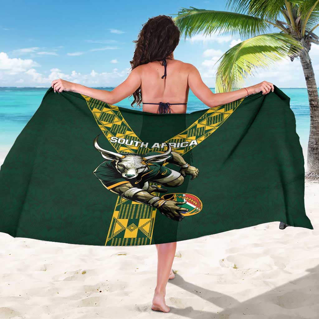 Green sarong, back view, with yellow geometric band and large animal crest