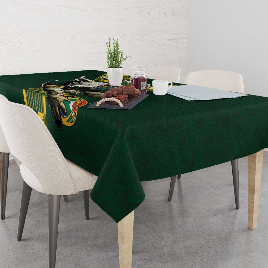 Green tablecloth with bull graphic and yellow patterned strip across the edge