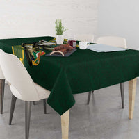 Green tablecloth with bull graphic and yellow patterned strip across the edge
