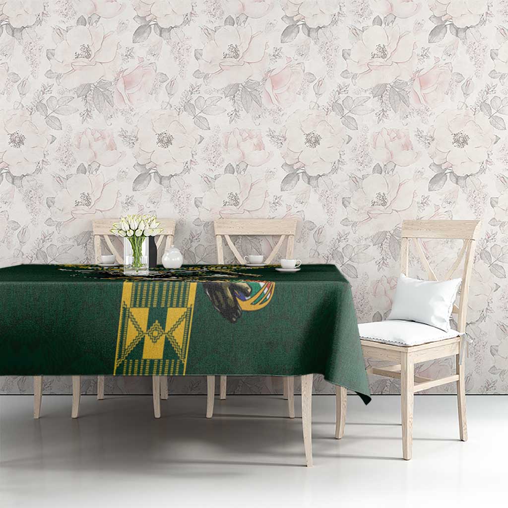 Green tablecloth with central bull emblem and yellow patterned panels