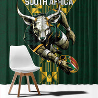 Close view of green curtain with South Africa rugby face emblem in yellow border