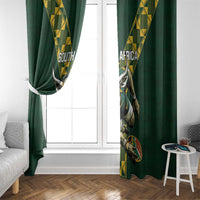Green window curtains with South Africa rugby emblem print and yellow geometric side panels