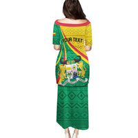 Long off-shoulder dress, back view, green yellow red with YOUR TEXT and crest print