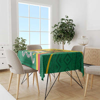 Green rectangular tablecloth with bold geometric print and yellow and blue accents