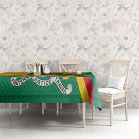 Green patterned tablecloth with multicolor stripe border and Fraternite/Justice/Travail text