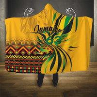 Yellow hooded blanket with large Jamaica 63 graphic and colorful geometric stripe band