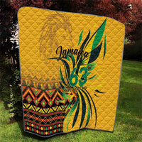 Yellow quilt blanket with green bird-like graphic and "Jamaica 63" text