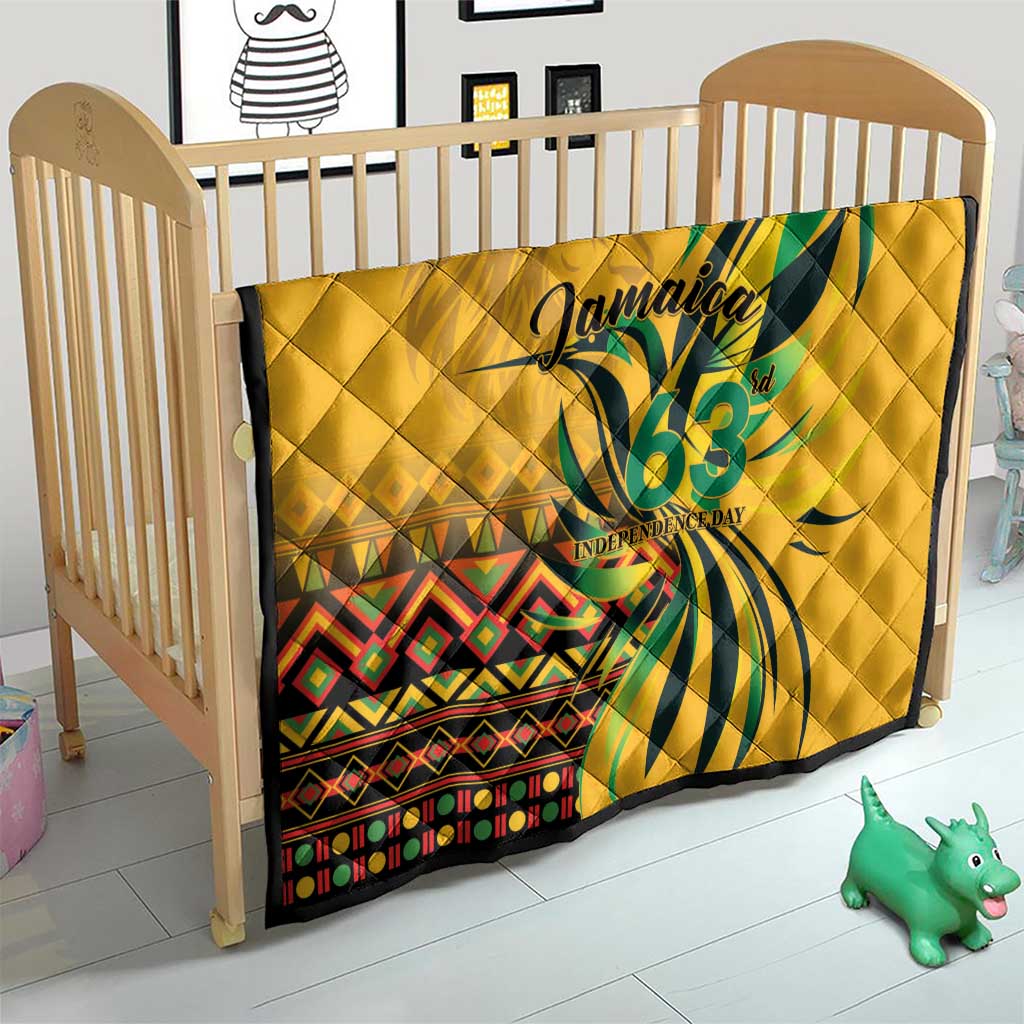 Yellow quilt on baby crib featuring green "Jamaica 63" Independence Day graphic