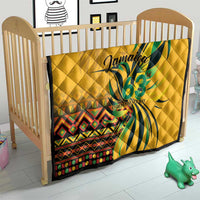 Yellow quilt on baby crib featuring green "Jamaica 63" Independence Day graphic