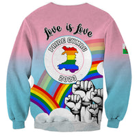 Unisex pink-to-blue sweatshirt with 'love is love' Pride Cymru 2023 badge and fists