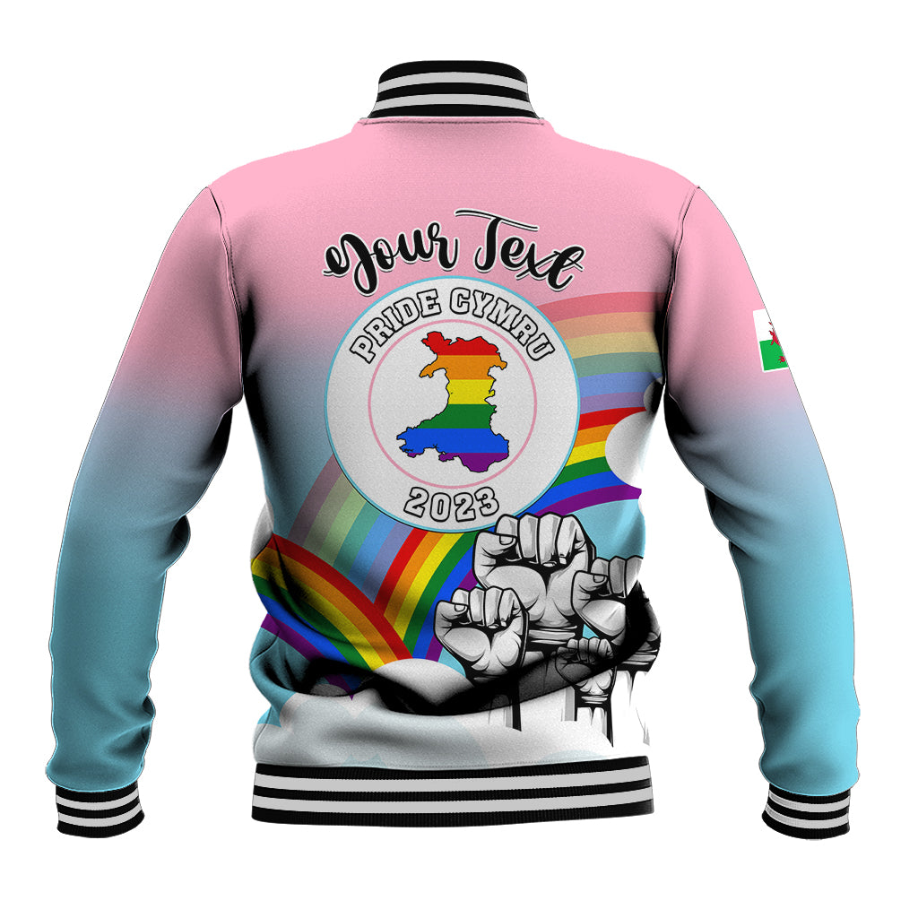 Back of pink-to-blue gradient baseball jacket with Pride Cymru logo and striped cuffs