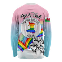 Pink long sleeve shirt back with Pride Cymru 2023 badge, rainbow band, fist graphic