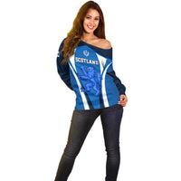 Blue off-shoulder rugby sweater with white vertical stripes and Scotland lion graphic