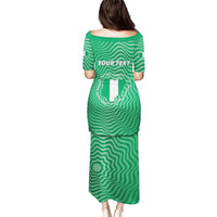 Green long dress with wavy stripes, centered text block, boat neckline, short sleeves
