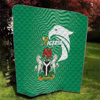 Green Nigeria quilt with quilted diamonds and large emblem graphic, folded corner view