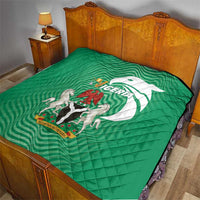 Green Nigeria quilt on a bed, quilted surface with central emblem and flag-style design