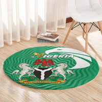 Green circular area rug with Nigeria emblem and lion-and-shield center design
