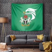 Green Nigeria flag tapestry with central coat of arms and bird motif, wall hanging above sofa.