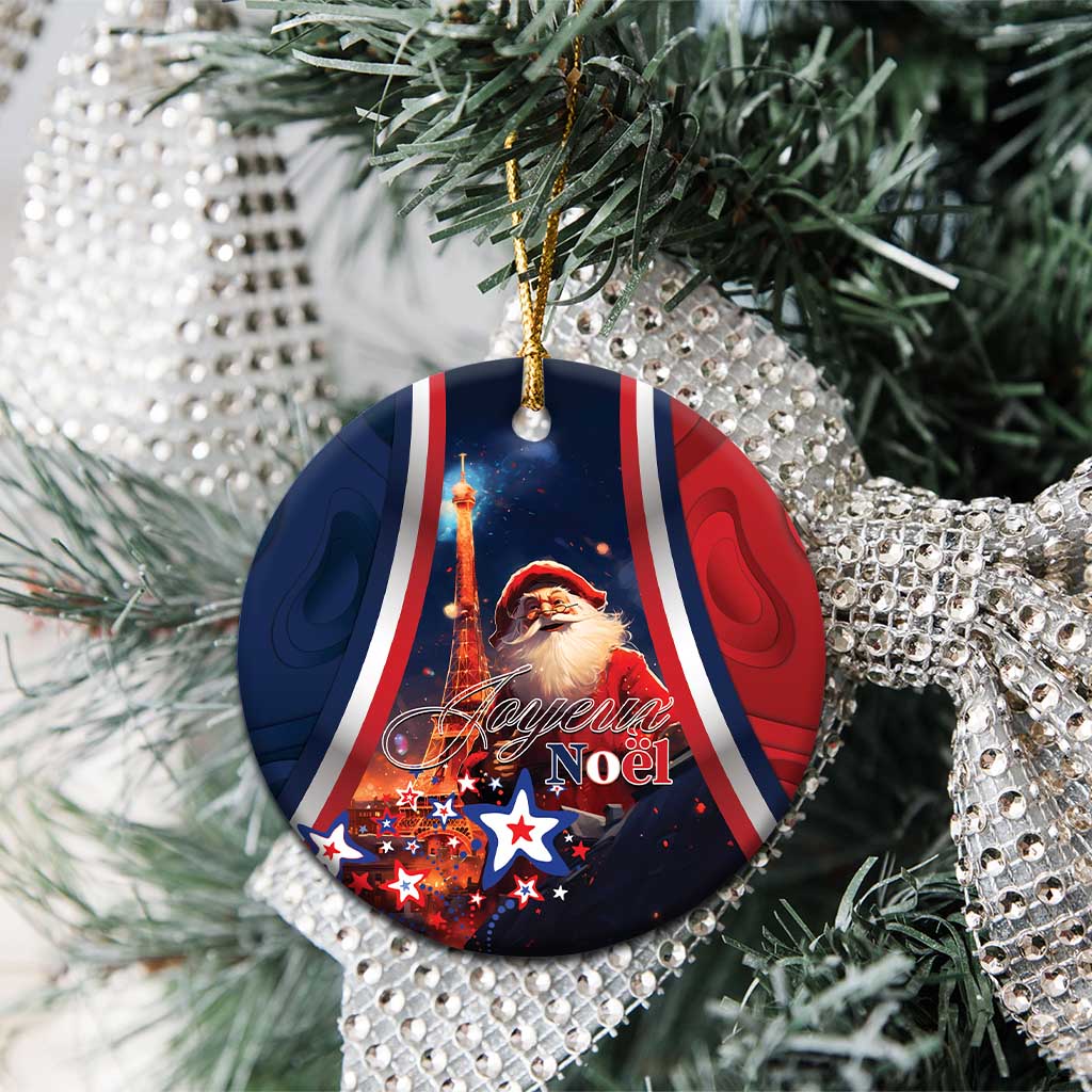 Blue round ceramic ornament with Santa, Eiffel Tower, and “Joyeux Noel” on tree