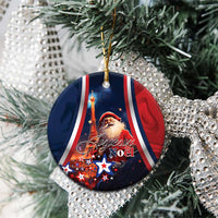 Blue round ceramic ornament with Santa, Eiffel Tower, and “Joyeux Noel” on tree