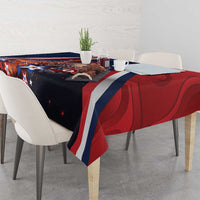 Christmas tablecloth draped on table, navy base with red and blue stripe panels