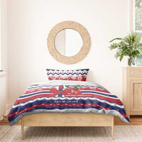 Christmas bedding set on wooden bed: red and blue Norway stripe design with bow and badge