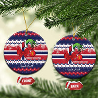 Round ceramic Christmas ornament with red bow, green figure, Norwegian text, gold loop