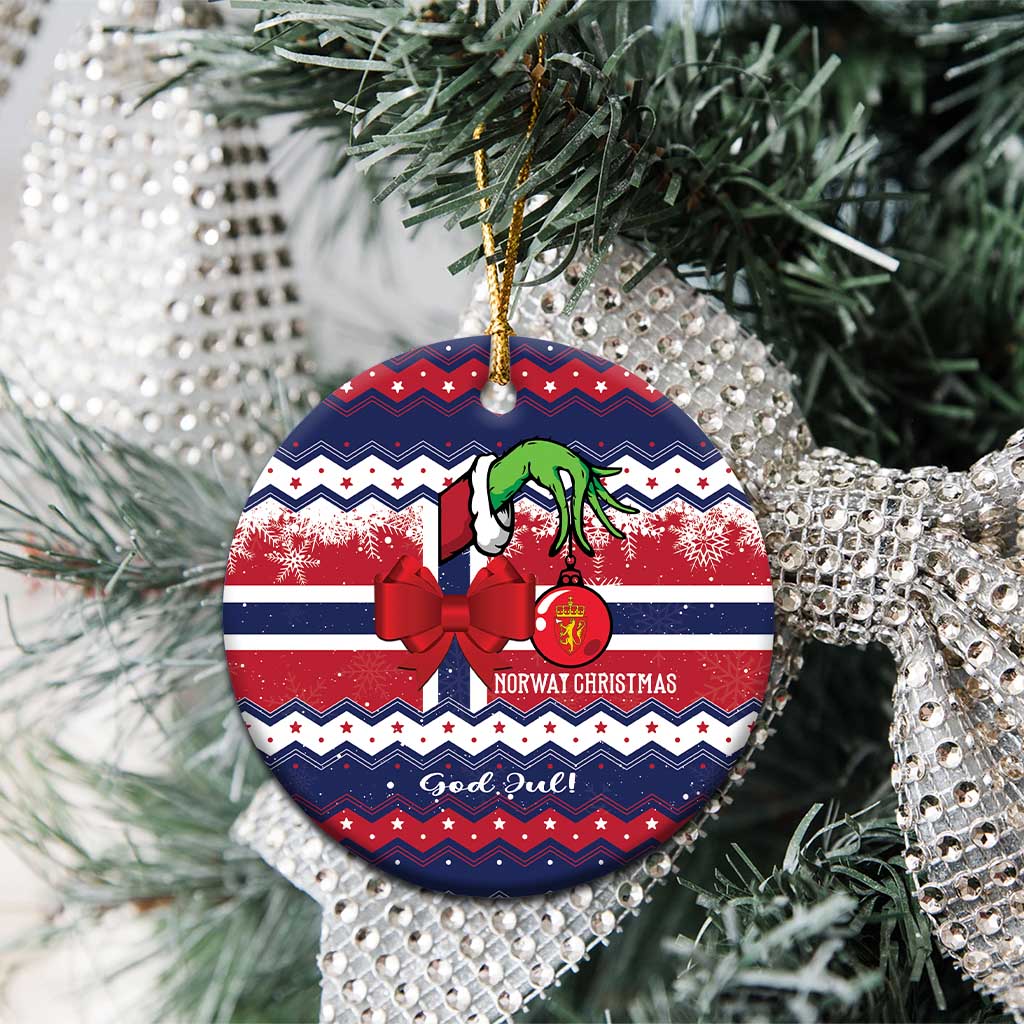 Round ceramic ornament on tree with red bow, green figure, "God Jul" and gold hanger