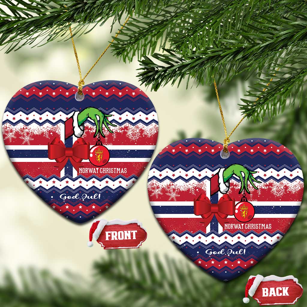 Heart-shaped ceramic ornament with red bow, green figure, "God Jul" text, gold hanging loop