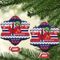 Two heart-shaped ceramic ornaments on branches: dark blue, red bow, green figure, gold loops
