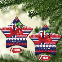 Star-shaped ceramic Christmas ornaments with red bow, green figure, "God Jul" text, gold hangers