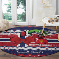 Round Christmas rug with blue zigzag stripes, red bow, green goat, and 'Norway Christmas'