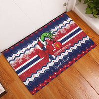 Blue and red Christmas rubber doormat laid diagonally, bow, elf figure, and striped pattern