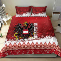 Red and white Christmas bedding set on bed: eagle crest center graphic with festive patterned hem.
