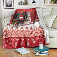 Red Christmas blanket with Austrian eagle crest, snowflakes, and festive zigzag pattern